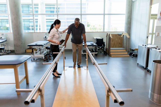 A stroke victim undergoes rehabilitation with a physical therapist. May is National Stroke Awareness Month in the U.S.
